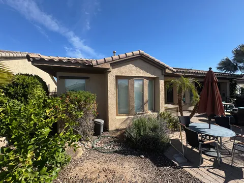 Repainted stucco and trim on a back patio overlooking a paver deck