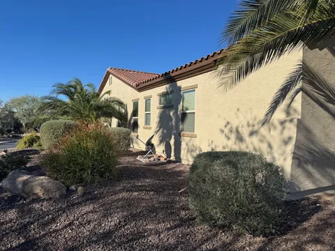 Freshly repainted tan stucco home exterior with desert landscaping in the East Valley