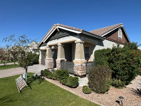 Craftsman-style home with porch columns and stone bases masked for repainting