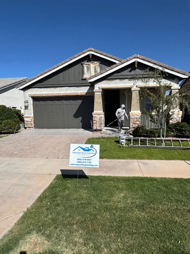 Maricopa Valley Painting crew repainting a home with a company yard sign out front